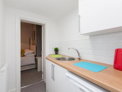 a kitchen with a sink and a counter top at Townhouse @ 166 Ruskin Road Crewe in Crewe