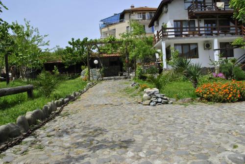a house with a stone path in front of it at ART STUDIO capitain in Sinemorets
