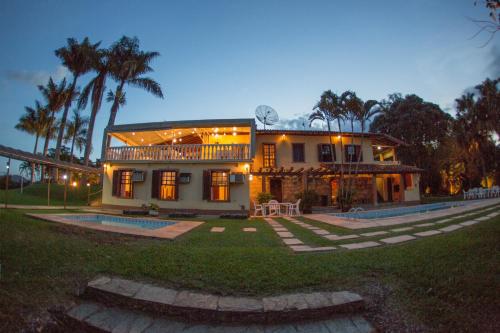 a large house with lights on the front of it at Hotel Fazenda Horizonte Belo in Brumadinho