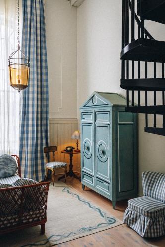 a living room with a blue cabinet in a room at Hotel Peter and Paul, an Ash Hotel in New Orleans