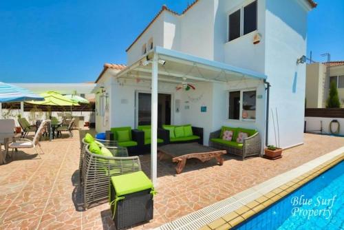 a villa with a swimming pool and a patio at Villa Julia in Ayia Napa