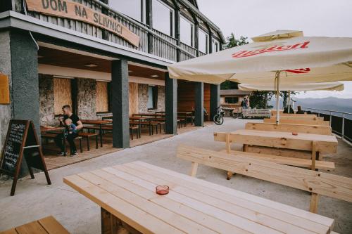 a group of tables and umbrellas outside of a restaurant at Dom na Slivnici in Cerknica