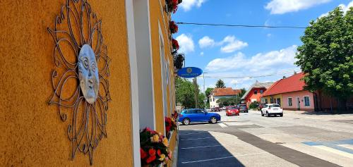 a sign on the side of a building next to a street at Hostel Sonce in Ptuj