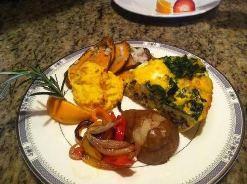 a plate of food with eggs and vegetables on a table at A Mighty Oak B&B in Pilot Mountain