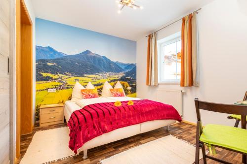 a bedroom with a bed with a view of mountains at Annas - Appartements in Flachau