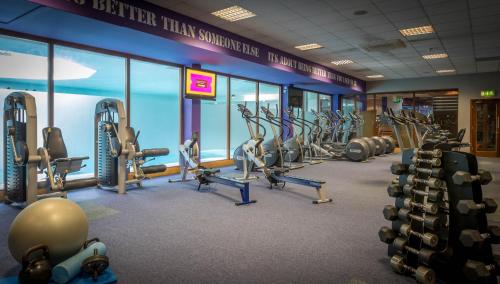 a gym with a row of treadmills and machines at Talbot Hotel Carlow in Carlow