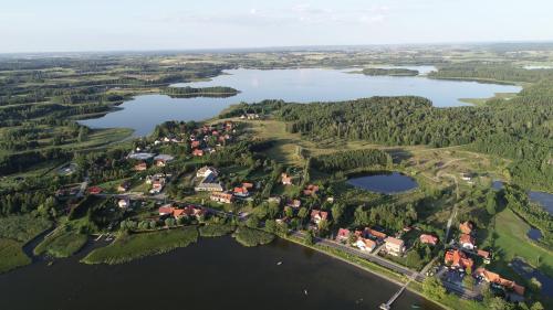an aerial view of a village on the shore of a lake at Stara Kuźnia Mazurska in Węgorzewo