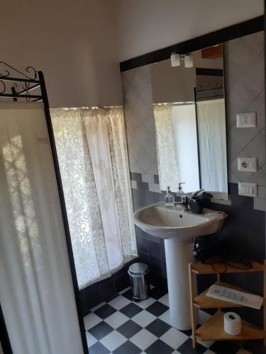 a bathroom with a sink and a mirror at Contrada Zerbate in Aci SantʼAntonio