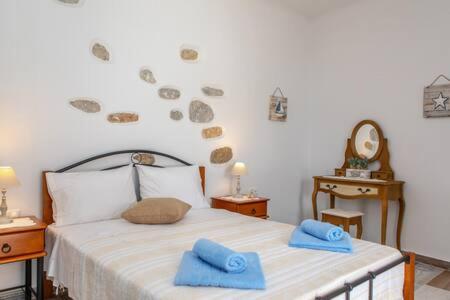 a bedroom with a bed with blue towels on it at Vintage House Naxos in Glinado Naxos