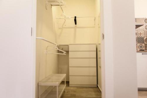 a small bathroom with a sink and a shelf at Marxalenes Apartments in Valencia