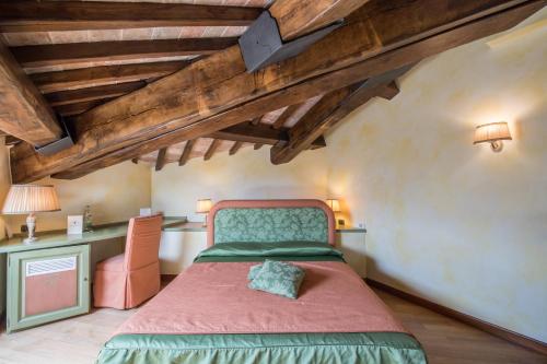 a bedroom with a bed in a room with wooden ceilings at Molino Del Duca Cesi in Terni