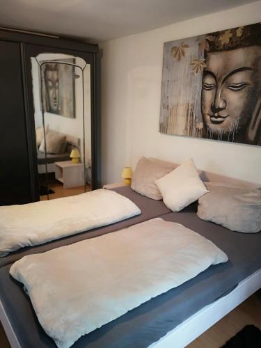 a bedroom with two beds and a painting on the wall at Ferienhaus HCR Grimmen in Grimmen