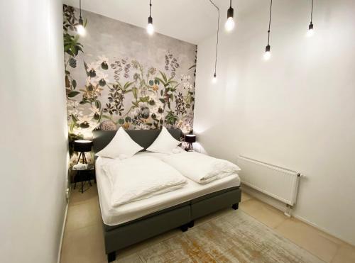 a bedroom with a bed with a floral wall at Loft directly next to Oktoberfest and downtown in Munich