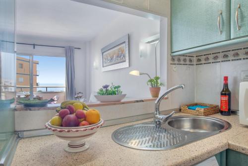 a kitchen with a sink and a bowl of fruit at Sweet Holiday Place - Benalmadena Costa in Benalmádena