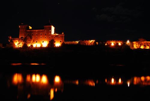 a castle at night with its lights on at Castell de Riudabella in Vimbodí