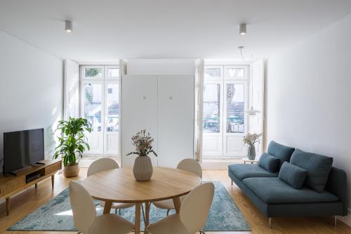 a living room with a blue couch and a table at São Vicente 1797 Apartments in Lisbon