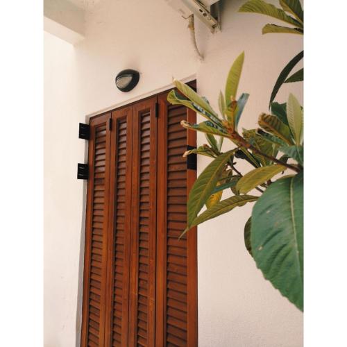 a wooden door with a clock on a wall at Hotel Ritsa in Kamena Vourla