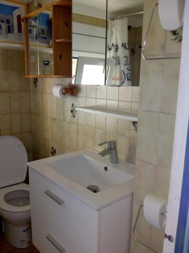 a bathroom with a white sink and a toilet at Rosas-Puig Rom -VISTA MAR in Roses