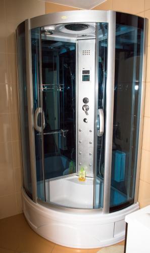 a small shower in a bathroom with a glass door at Casa Hortensia in Mangalia