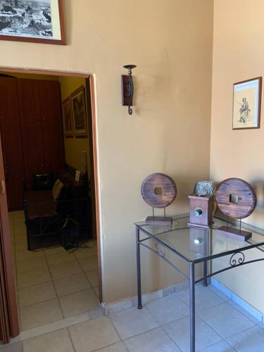 two chairs and a glass table in a room at AMFITRION CITY in Gythio