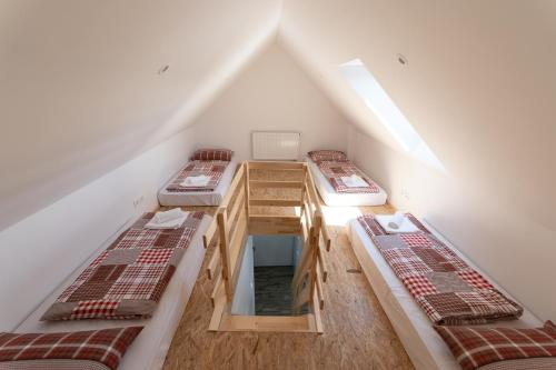 a attic room with three bunk beds in it at Hiša Janko Bled in Bled