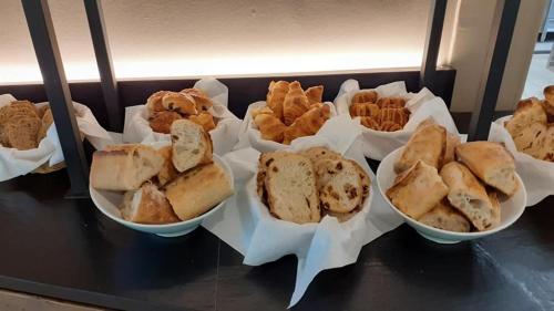 a group of bowls of sandwiches and crackers on a counter at Hôtel Villa Glanum et Spa in Saint-Rémy-de-Provence