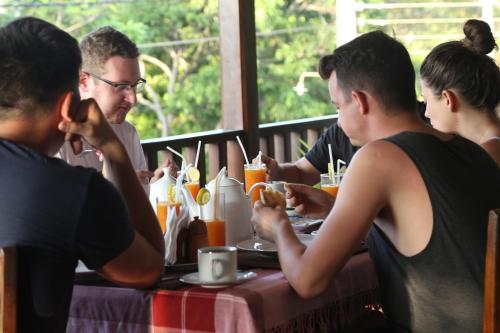 a group of people sitting at a table eating at Seafood Restaurant and Motel in Tangalle