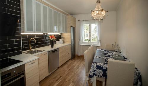 a kitchen with a table and a dining room at Klintvägen Apartments in Mariehamn