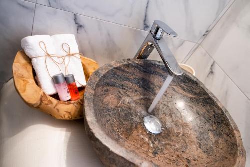 a sink with a faucet in a bathroom at Anamnisi Mykonos in Mikonos