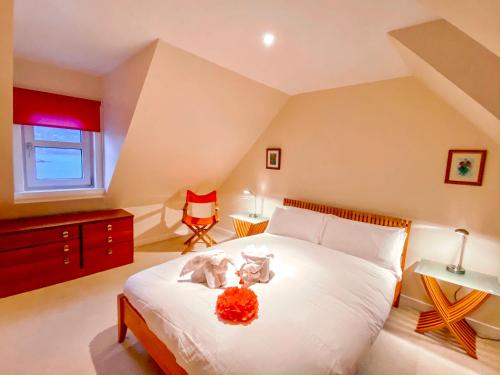 a bedroom with a bed with two stuffed animals on it at Harbour View in Portree