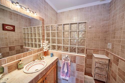 a bathroom with a sink and a mirror at Casa Rural Mi Cortijo in Nerja