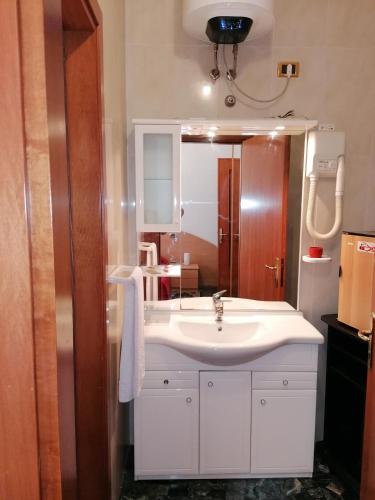 a bathroom with a white sink and a mirror at Sacco Alloggi in Rovigo
