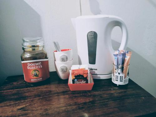 a table with a coffee pot and other items on it at H 58 in Amsterdam