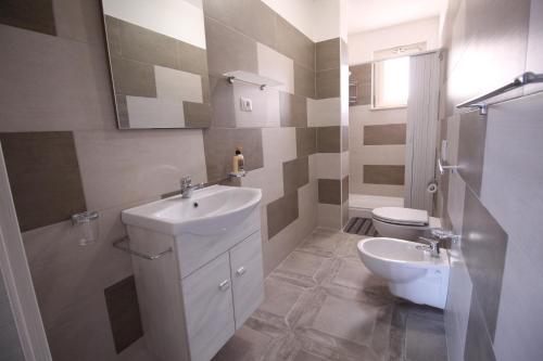 a bathroom with a sink and a toilet at Chiaro di Luna in Santa Domenica
