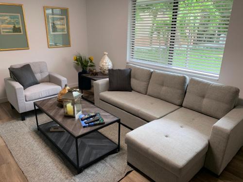 a living room with a couch and two chairs and a table at Harbourside Flats in Fort Lauderdale
