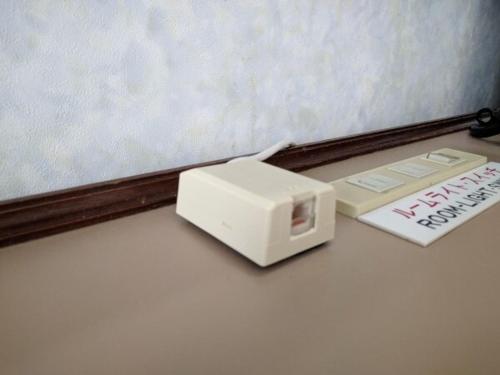 a white toaster sitting on a table next to a book at Hotel Harbour Yokosuka - Vacation STAY 86063 in Yokosuka