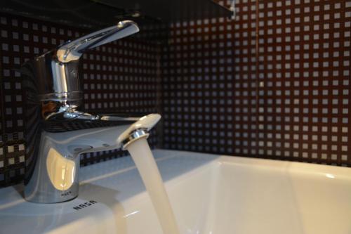 a bathroom sink with a faucet on top of it at Panoramic Holiday Apartment - Luxury Studio | Nuwara Eliya in Nuwara Eliya