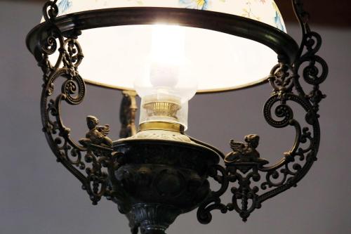 a black lamp with a light on top of it at Tanya Üdülőház in Garáb