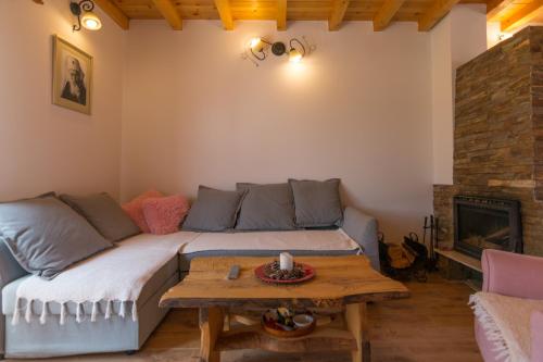 a living room with a couch and a table at Planinska kuca Popovic 3 in Ljuboš