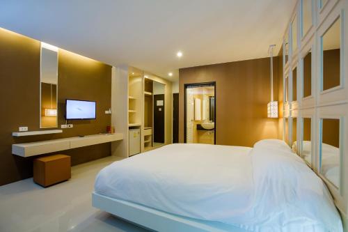 Säng eller sängar i ett rum på Naka Residence