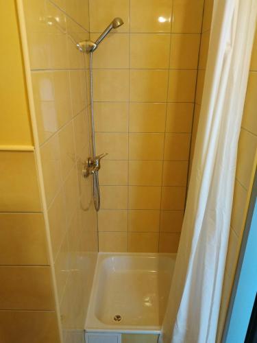 a bathroom with a shower with a tub at Kawalerki z Kuchnią - self check in - Studios with Kitchen in Poznań