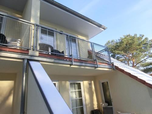 a balcony on the side of a house at Kiefernblick in Ostseebad Karlshagen