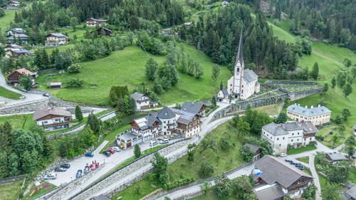 an aerial view of a small village with a church at Sagritzerwirt in Großkirchheim