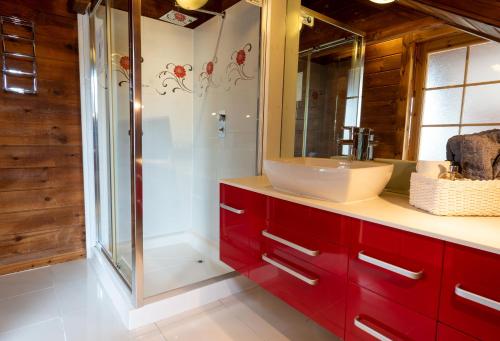 a bathroom with a sink and a glass shower at Pine Tree Lodge - Pentney Lakes in Pentney