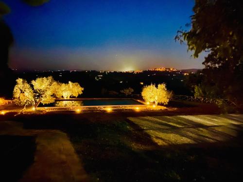 a view of a garden at night with lights at LaChiusa Tuscany in Montefollonico