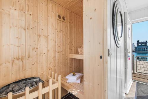 a room with a wooden wall with a tub at Sunseeker in Olpenitz
