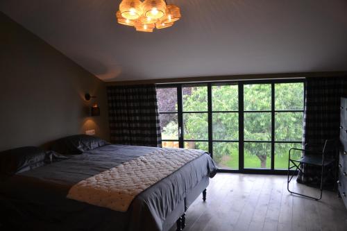 Un ou plusieurs lits dans un hébergement de l'établissement Maison du chien vert