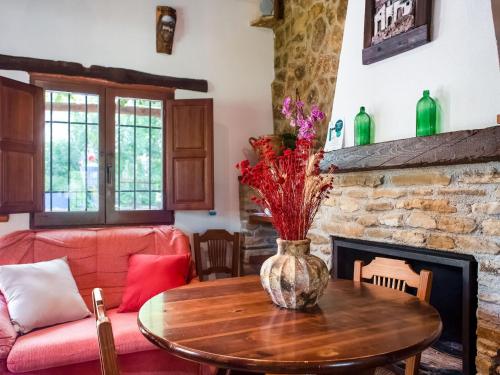 a living room with a table and a fireplace at Belvilla by OYO Molinos de Padul Misqueres in Padul