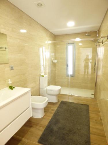 a bathroom with a toilet and a sink and a shower at Moradia Faria in Fataca
