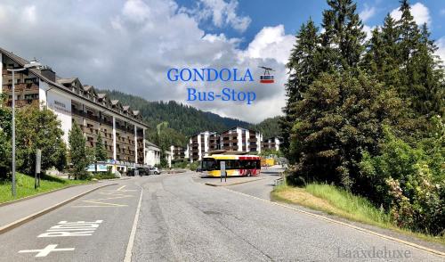 a bus stop sign on the side of a road at Rancho Laaxdeluxe in Laax